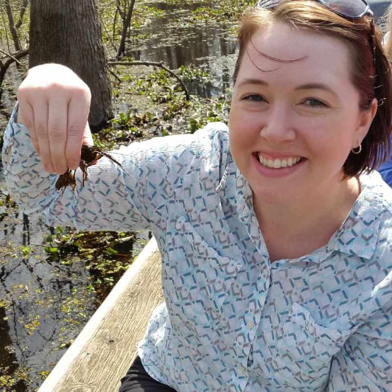 a person smiling in a park