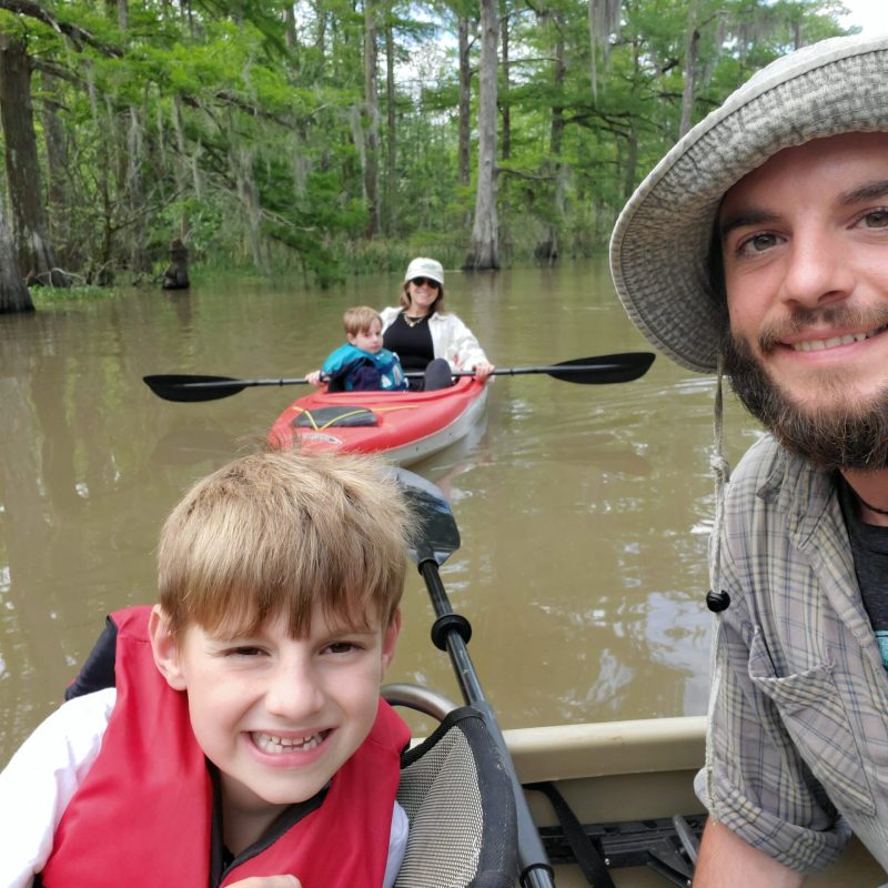 a man sitting on a boat in the water