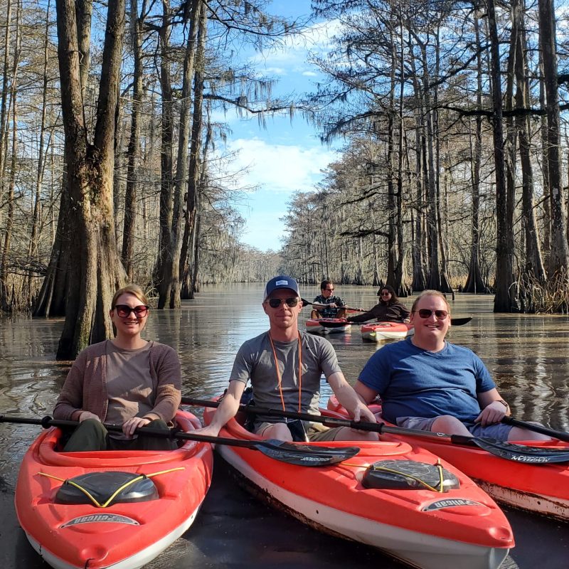 a group of people riding on the back of a boat
