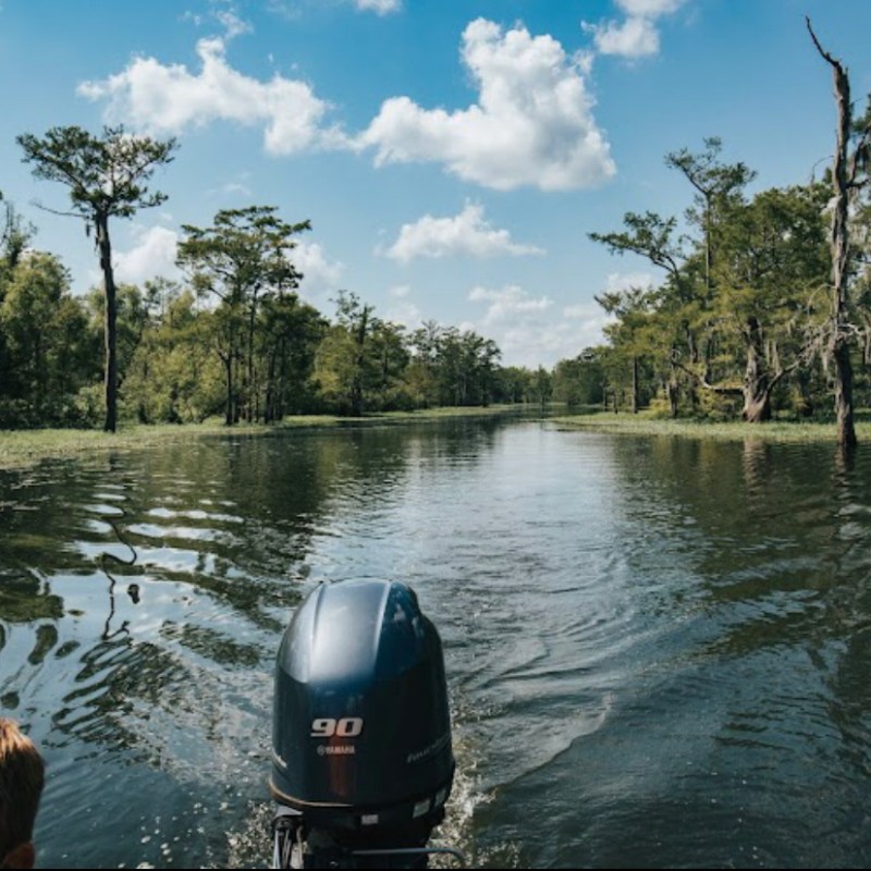 a person standing next to a body of water