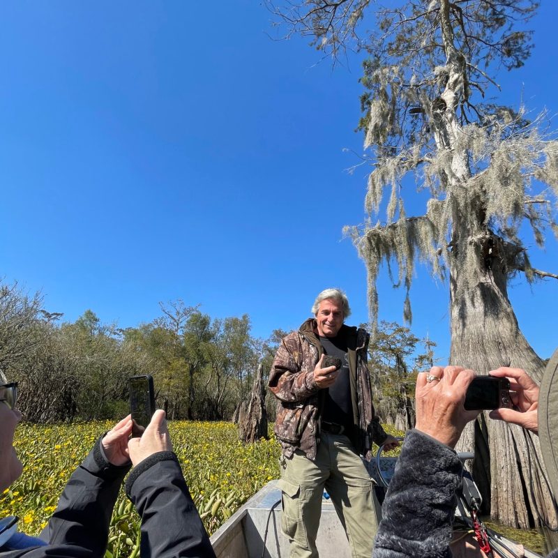 a group of people standing next to a tree