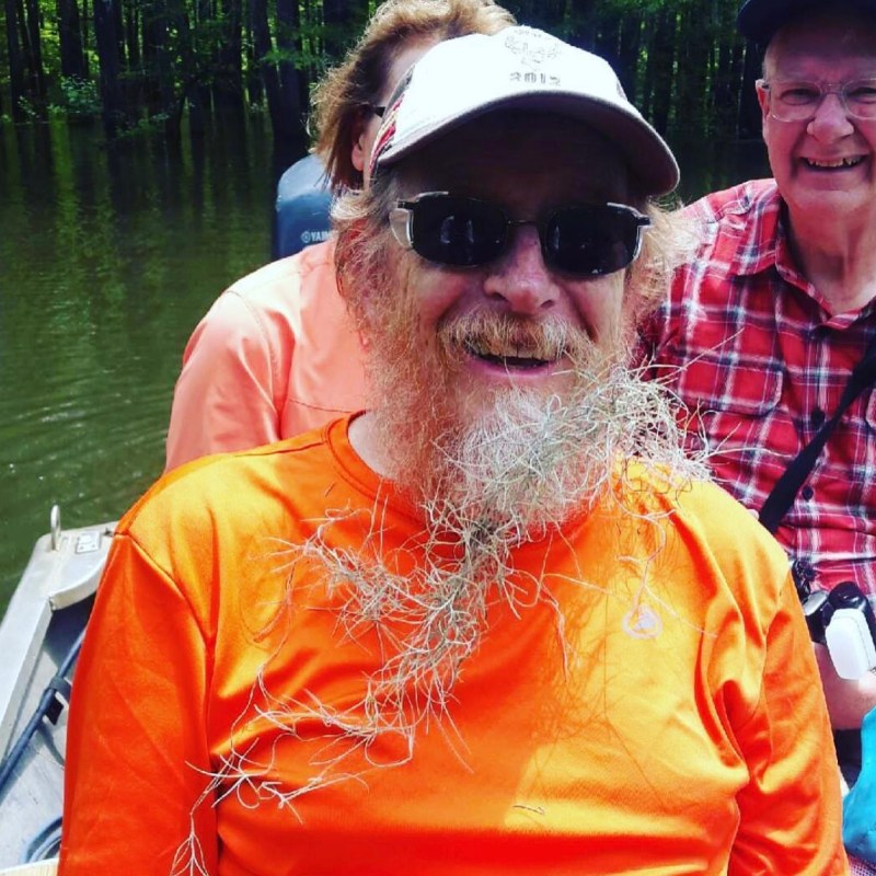 a man and a woman sitting on a boat in the water