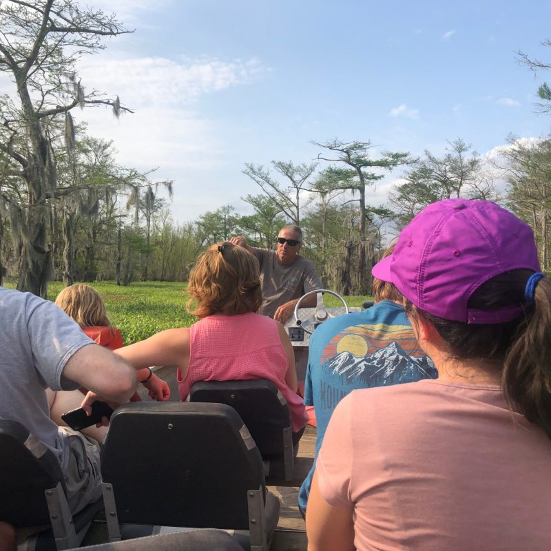 a group of people sitting at a park