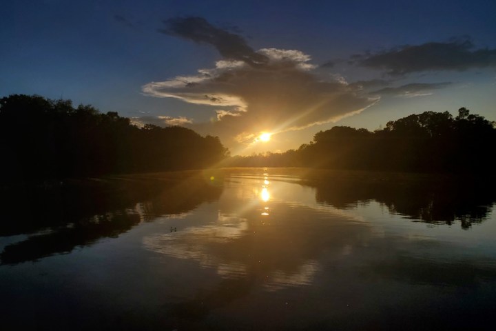 a group of clouds in the sky over a body of water