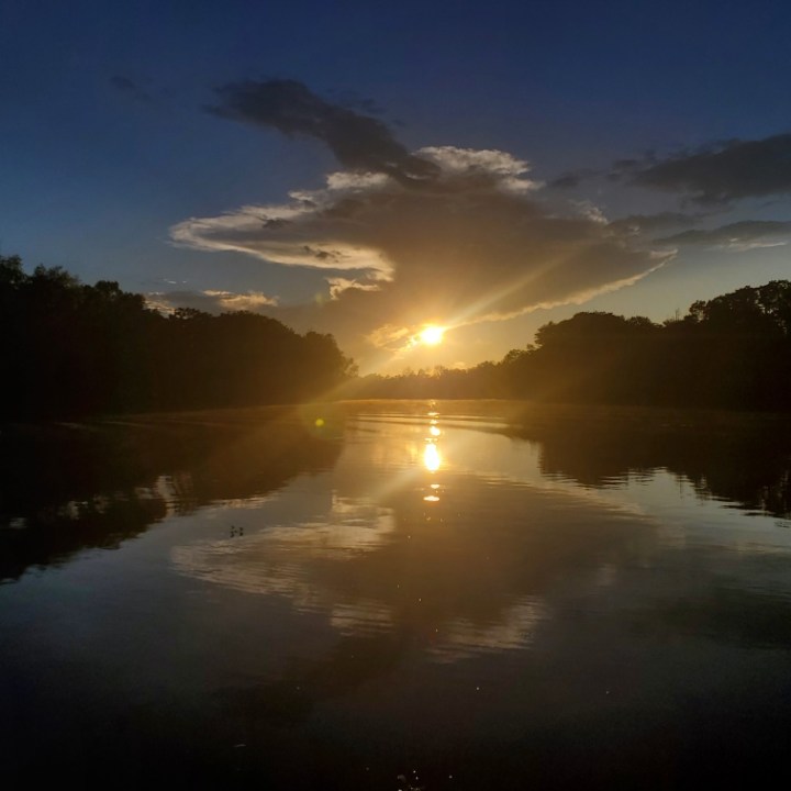 a group of clouds in the sky over a body of water